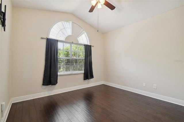 spare room featuring ceiling fan, dark hardwood / wood-style flooring, and vaulted ceiling