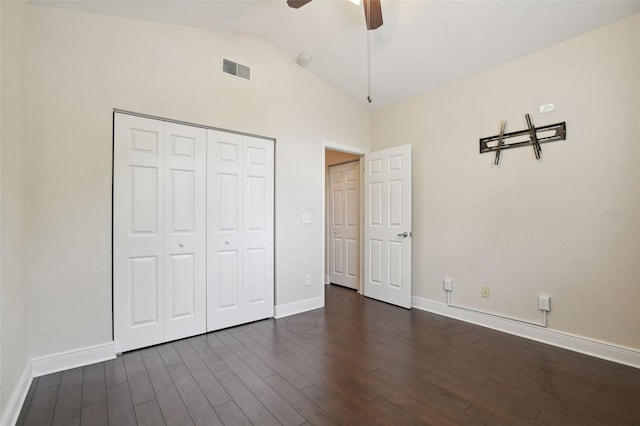 unfurnished bedroom featuring ceiling fan, dark wood-type flooring, high vaulted ceiling, and a closet