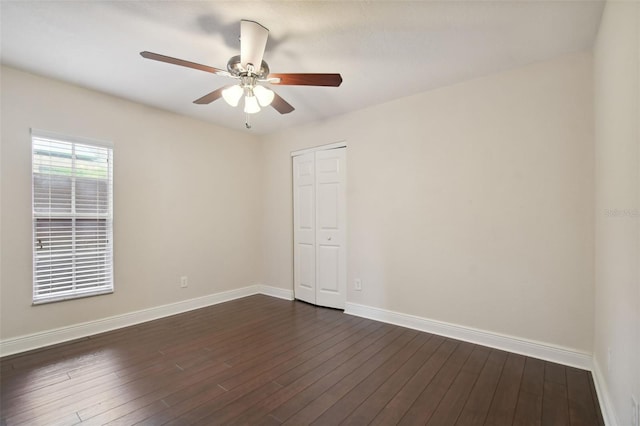 spare room featuring dark hardwood / wood-style flooring and ceiling fan