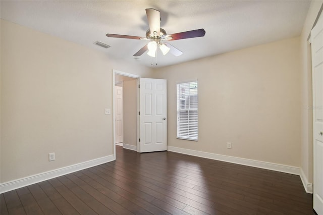 unfurnished bedroom with ceiling fan and dark wood-type flooring