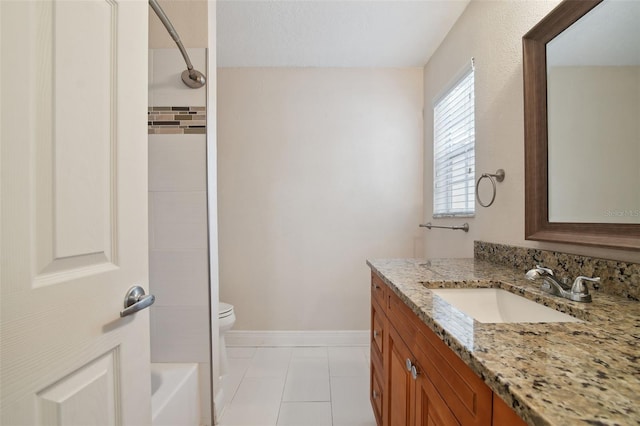 full bathroom featuring tile patterned floors, tiled shower / bath, vanity, and toilet