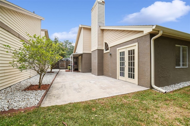 exterior space with a yard, a patio area, and french doors