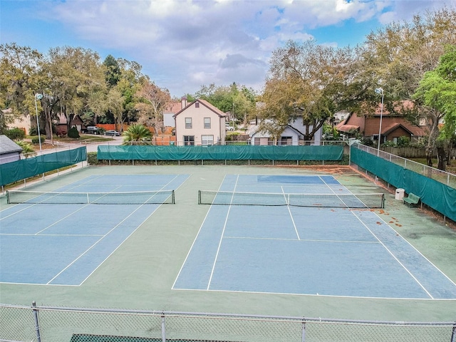 view of tennis court with basketball hoop