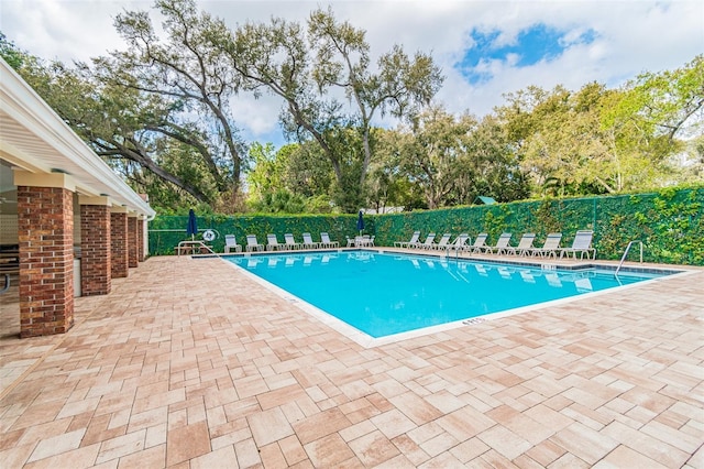 view of swimming pool featuring a patio area