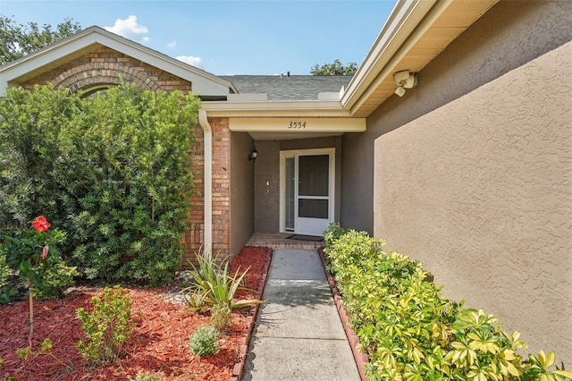 3554 Deer Run S, Palm Harbor, FL 34684 - property entrance featuring stucco siding