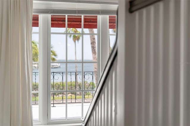 doorway to outside with plenty of natural light and a water view