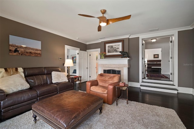 living room with hardwood / wood-style floors, ceiling fan, and ornamental molding