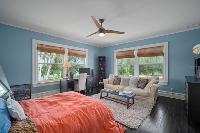 bedroom with multiple windows, ceiling fan, crown molding, and dark wood-type flooring