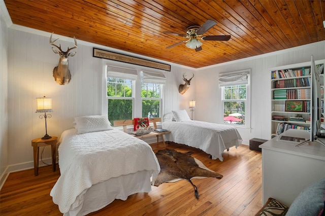 bedroom featuring wood-type flooring, ornamental molding, ceiling fan, and wooden ceiling