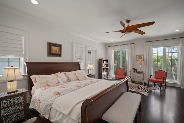 bedroom with ceiling fan, crown molding, and dark hardwood / wood-style floors