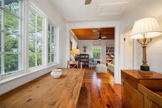 interior space featuring hardwood / wood-style floors, crown molding, and a healthy amount of sunlight