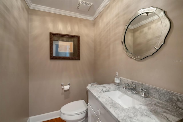 bathroom with vanity, ornamental molding, and toilet