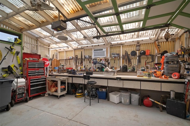 garage featuring a garage door opener and a wall mounted AC