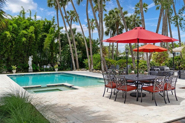 view of pool featuring a patio area and an in ground hot tub