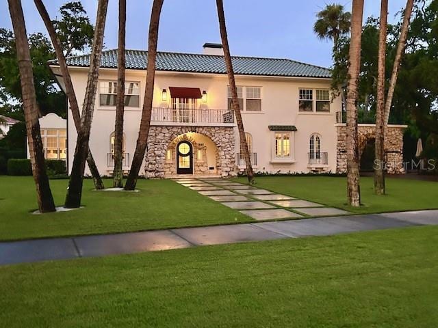 mediterranean / spanish home featuring a front yard