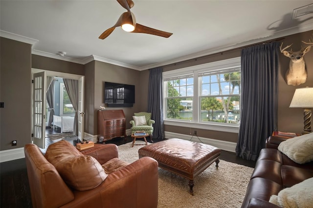 living room with plenty of natural light, wood-type flooring, and ornamental molding