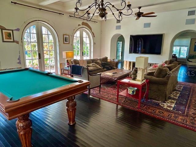 game room with ceiling fan, french doors, dark wood-type flooring, beamed ceiling, and billiards