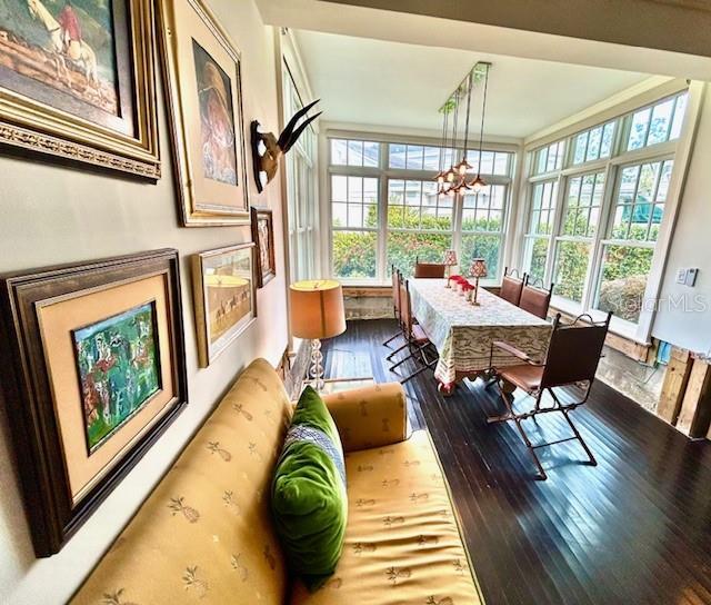 sunroom featuring a notable chandelier