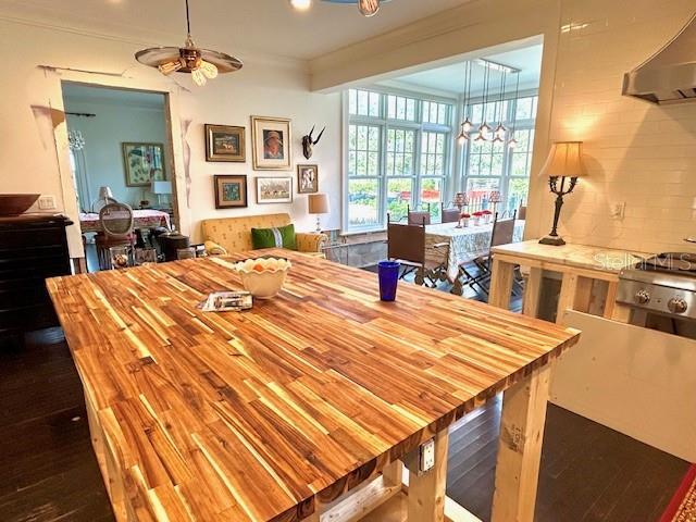 dining space featuring ceiling fan with notable chandelier