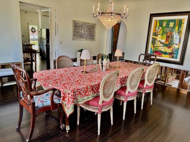 dining room featuring dark hardwood / wood-style floors and a chandelier