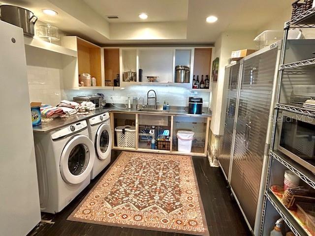 interior space featuring washer and dryer, dark hardwood / wood-style floors, and sink