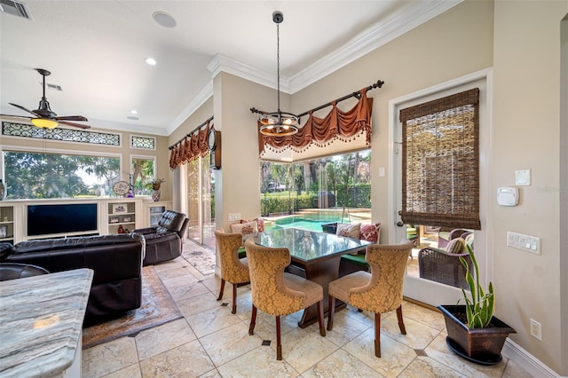 dining space featuring ceiling fan with notable chandelier and ornamental molding