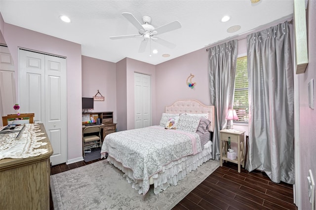 1227 Toscano Dr, Trinity, FL 34655 - bedroom with dark wood finished floors, two closets, ceiling fan, and recessed lighting