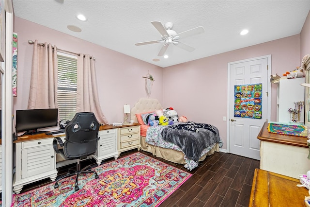 bedroom featuring a textured ceiling, ceiling fan, and dark wood-type flooring