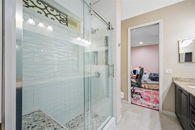 bathroom with tile patterned floors, vanity, toilet, and an enclosed shower