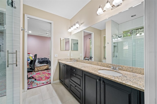 bathroom featuring ceiling fan, tile patterned flooring, vanity, and a shower with shower door