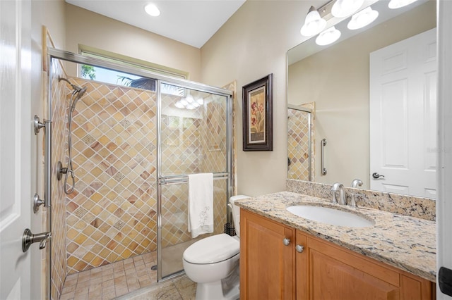 bathroom with tile patterned flooring, vanity, toilet, and walk in shower