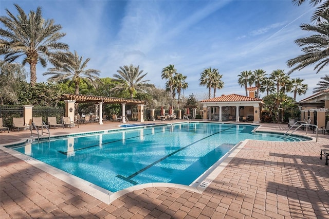 view of swimming pool featuring a patio and a pergola