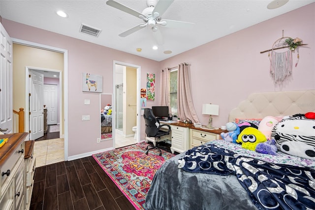 bedroom with connected bathroom, ceiling fan, and a textured ceiling