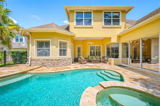 view of swimming pool with outdoor lounge area, ceiling fan, a patio area, and an in ground hot tub