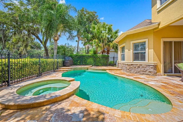 view of swimming pool with an in ground hot tub