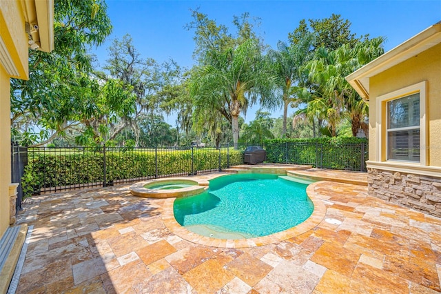 view of pool with a patio area and an in ground hot tub