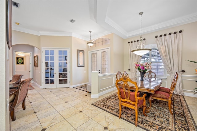 1227 Toscano Dr, Trinity, FL 34655 - dining area with french doors, ornamental molding, arched walkways, and baseboards