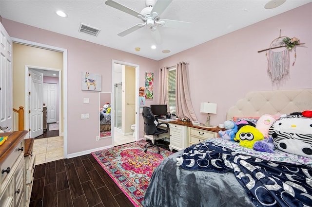 1227 Toscano Dr, Trinity, FL 34655 - bedroom with a desk, baseboards, wood finished floors, ensuite bath, and recessed lighting
