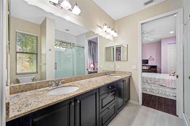 1227 Toscano Dr, Trinity, FL 34655 - ensuite bathroom with double vanity, a stall shower, baseboards, toilet, and ceiling fan