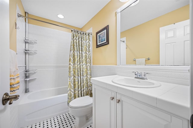 1227 Toscano Dr, Trinity, FL 34655 - full bath with vanity, toilet, shower / bathtub combination with curtain, tile walls, and wainscoting