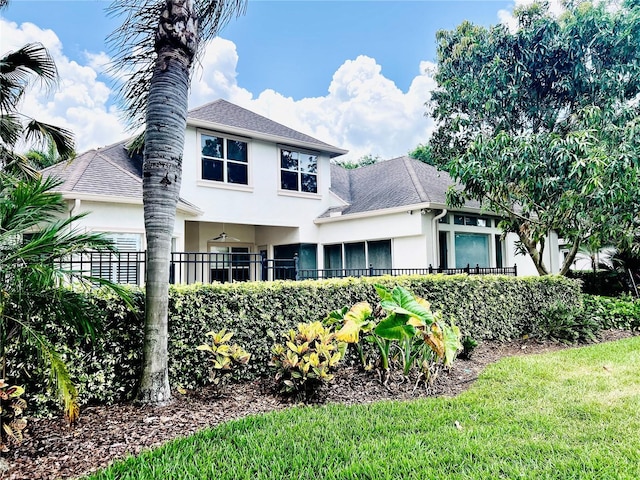 1227 Toscano Dr, Trinity, FL 34655 - rear view of house featuring stucco siding and a shingled roof