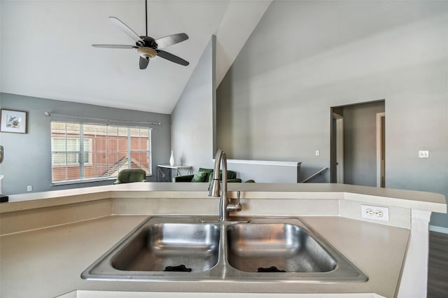 kitchen featuring ceiling fan, sink, and vaulted ceiling