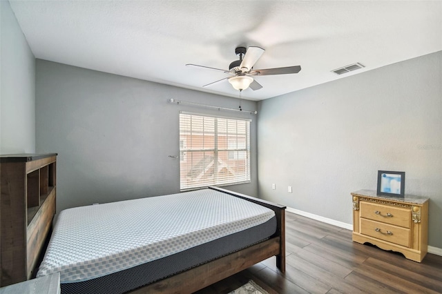 bedroom with ceiling fan and dark wood-type flooring