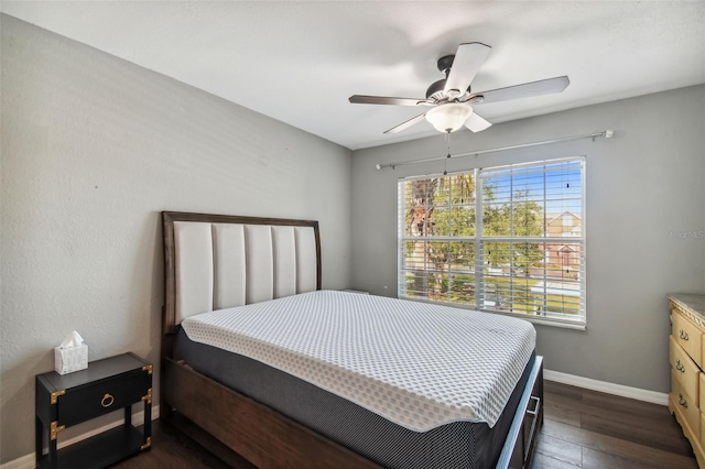 bedroom featuring ceiling fan and dark wood-type flooring