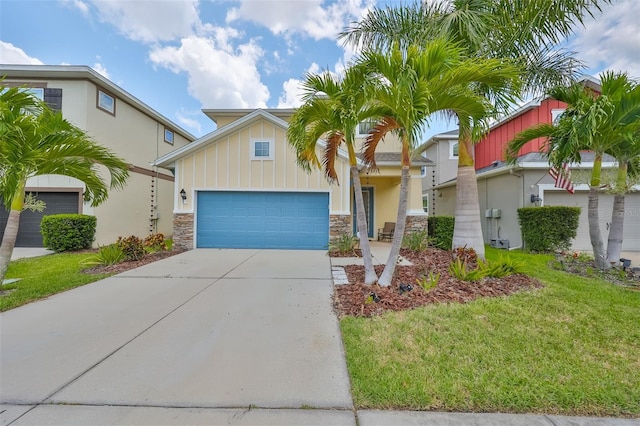 view of front of home with a front yard and a garage