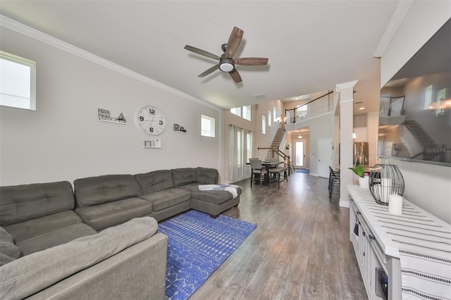 living room featuring hardwood / wood-style floors, ceiling fan, and ornamental molding