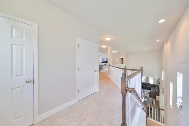 hallway featuring light carpet