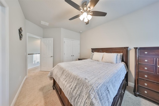 carpeted bedroom with a closet and ceiling fan