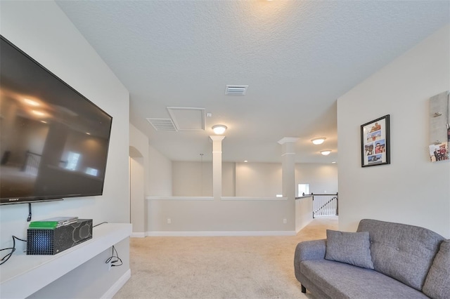 carpeted living room featuring a textured ceiling