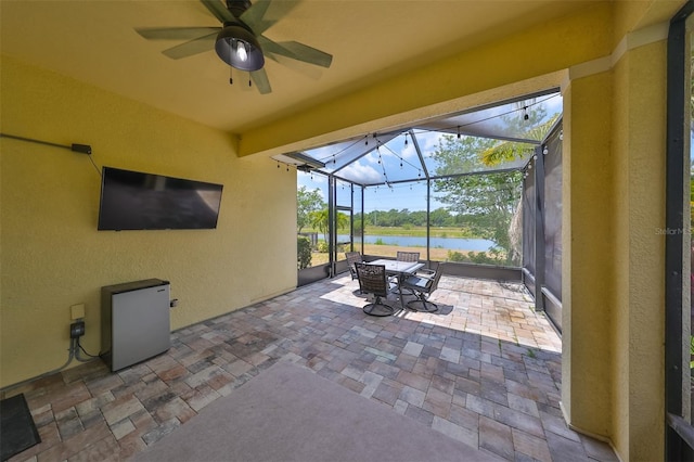 view of patio / terrace featuring ceiling fan and glass enclosure